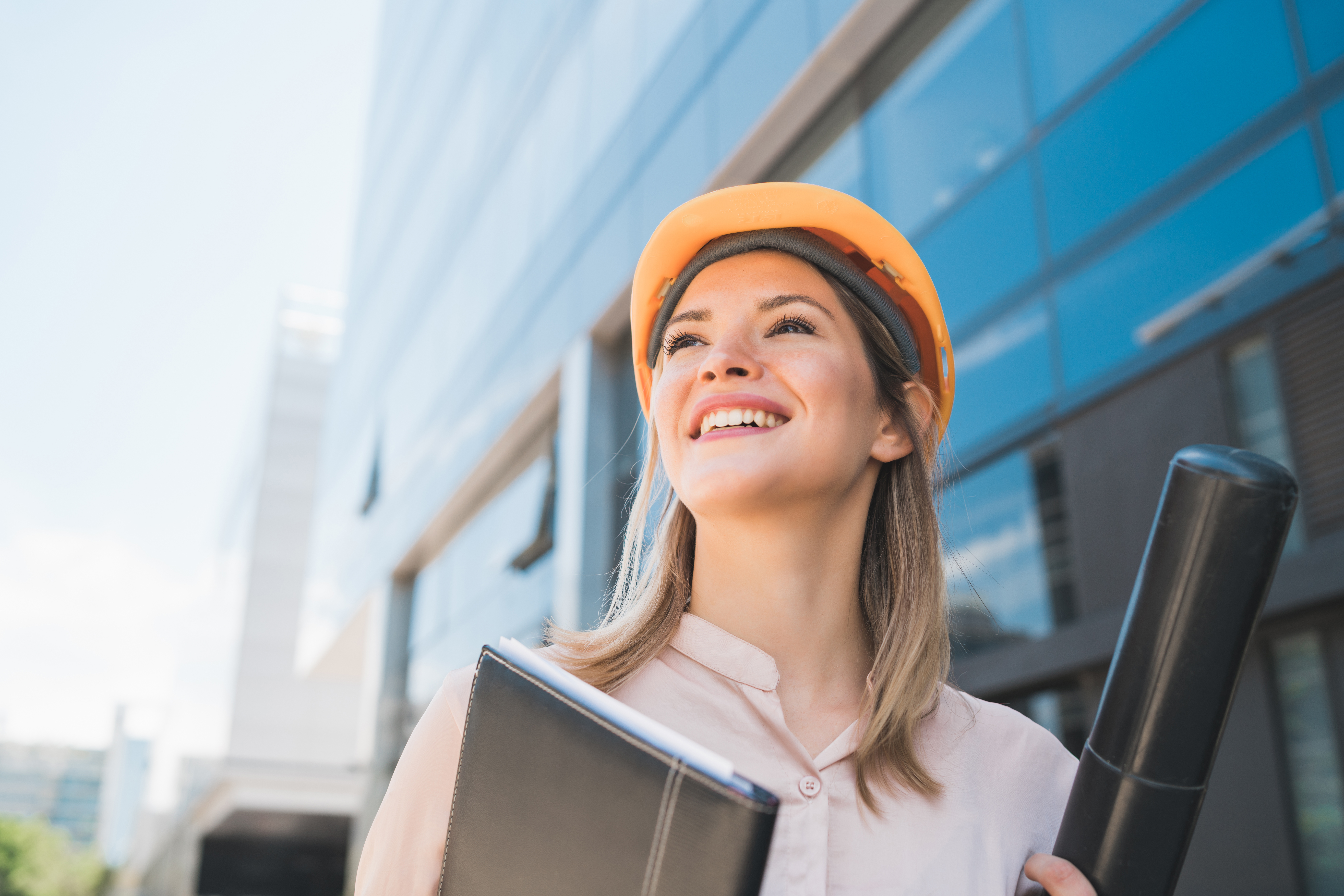 Woman in construction with a hard hat