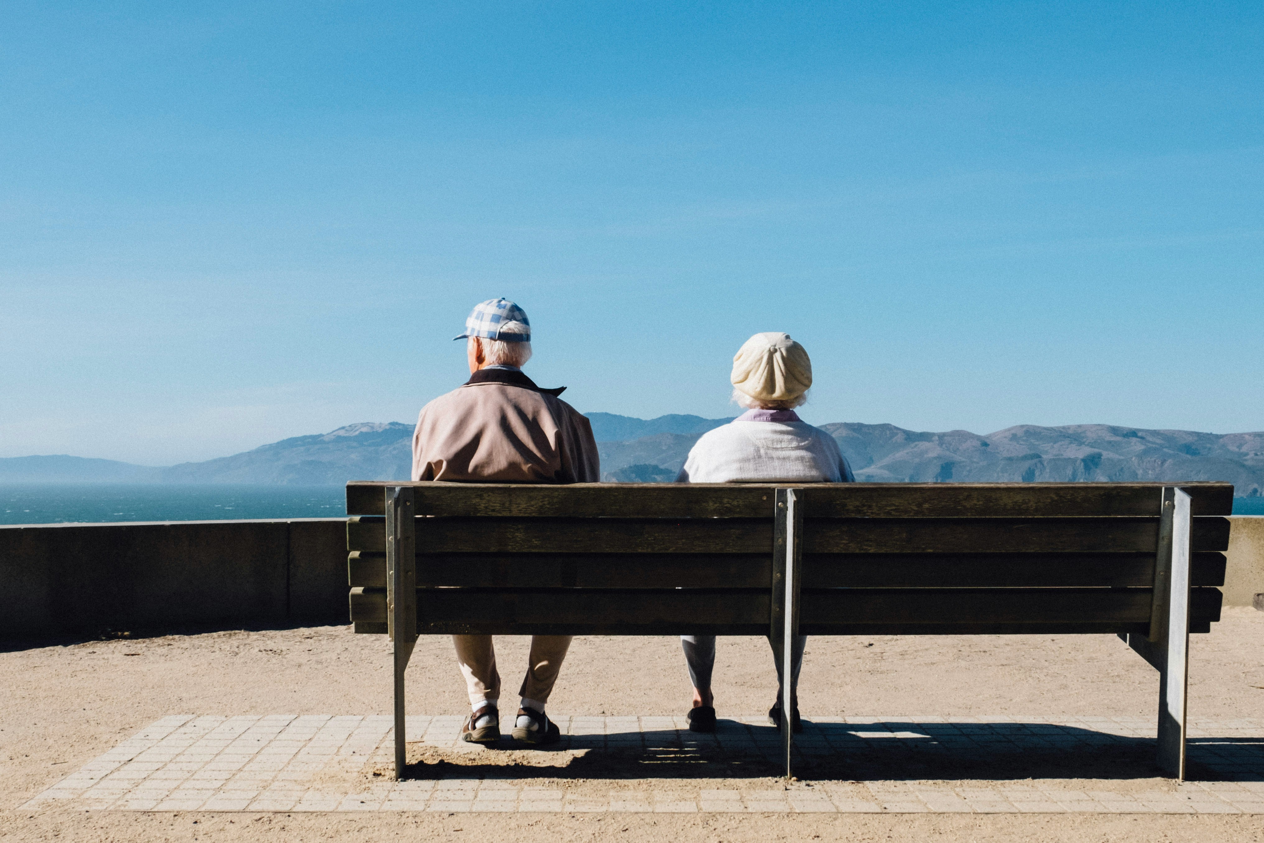 elderly couple sitting on a bench